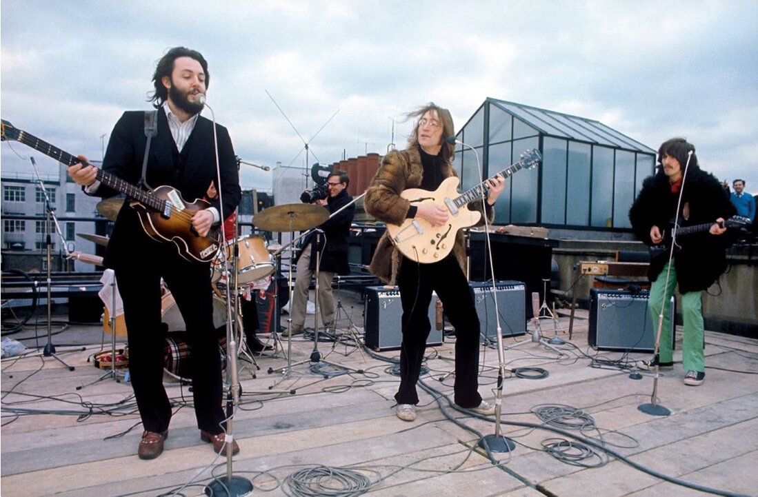 Band performing on a rooftop above a busy street